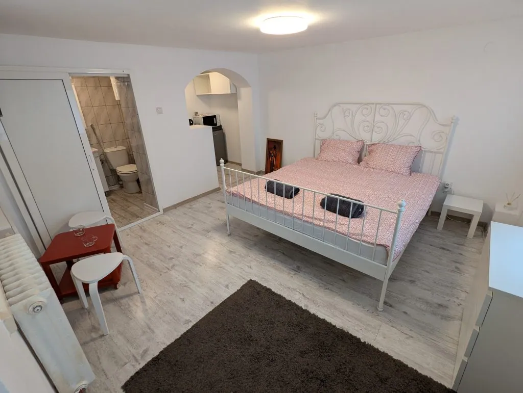 White double bed in the Serene Studio Bucharest private studio