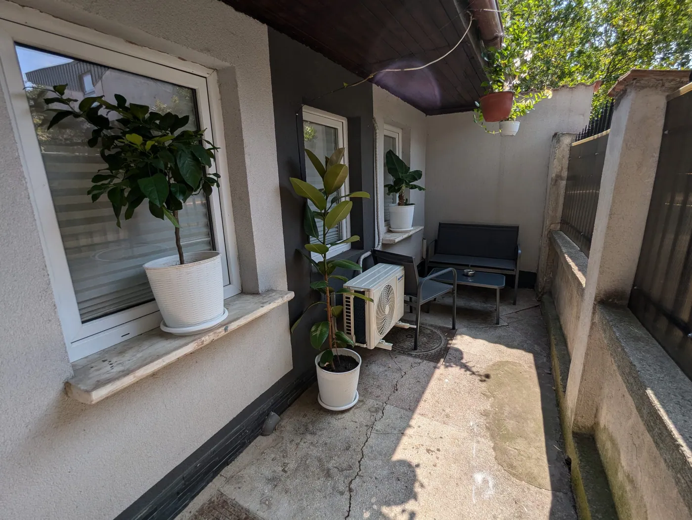 Private terrace at Serene Studio Bucharest with plants and bench